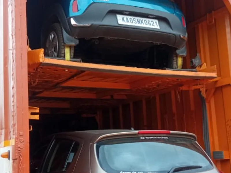 Passenger cars parked on upper and lower decks of specialized closed vehicle carrier