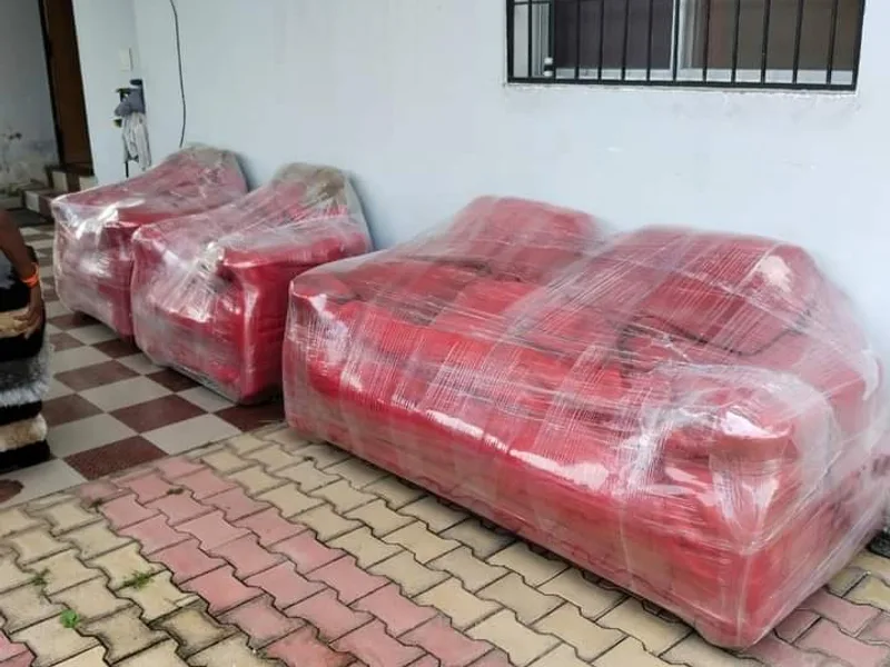 Leather sofa set wrapped in transparent protective film on residential porch