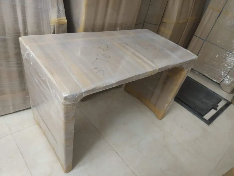 Heavy wrapped household furniture placed beside mini transport truck for loading